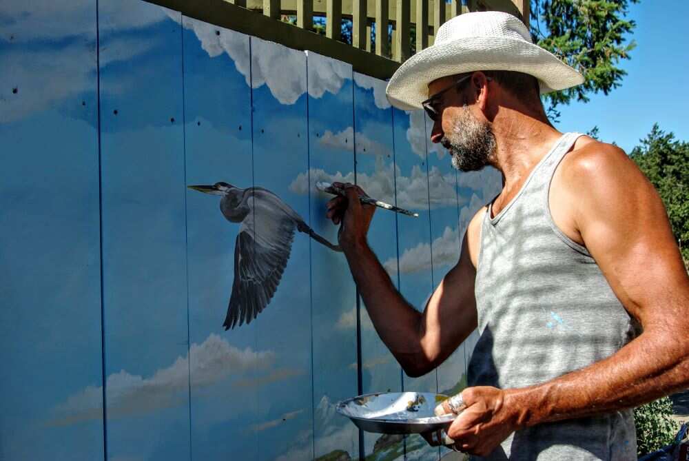 man painting for arts and gardens event